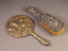 EMBOSSED SILVER BACKED DRESSING TABLE HAIR BRUSH, decorated with flower heads ad C scrolls,