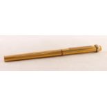 CARTIER, PARIS, GOLD PLATED BALLPOINT PEN, no 52267, the case oval and fluted with maroon