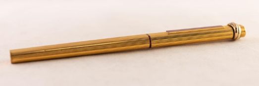 CARTIER, PARIS, GOLD PLATED BALLPOINT PEN, no 52267, the case oval and fluted with maroon