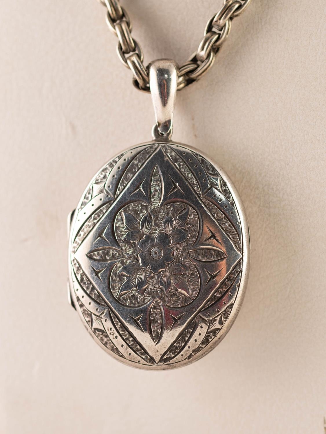 VICTORIAN SILVER FLORAL ENGRAVED OVAL LOCKET PENDANT, 1 3/4in (4cm) high, Chester 1881 on a SILVER - Image 2 of 3