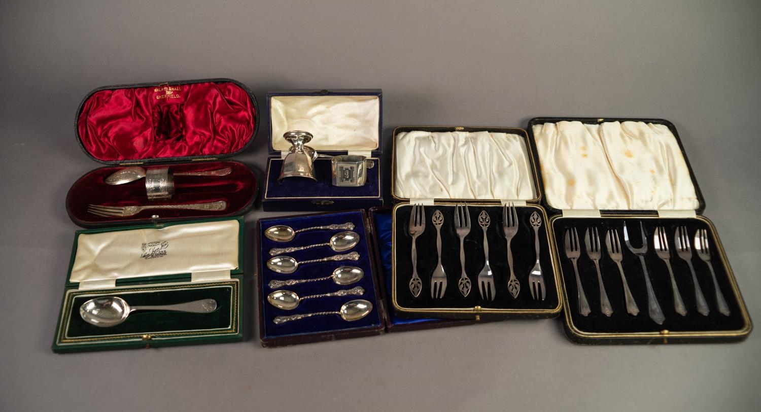 EDWARDIAN CASED CHASED SILVER CHRISTENING SPOON, FORK AND NAPKIN RING (originally with a knife,