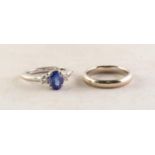 18ct WHITE GOLD, SAPPHIRE AND DIAMOND RING, with raised centre oval blue sapphire in a four claw