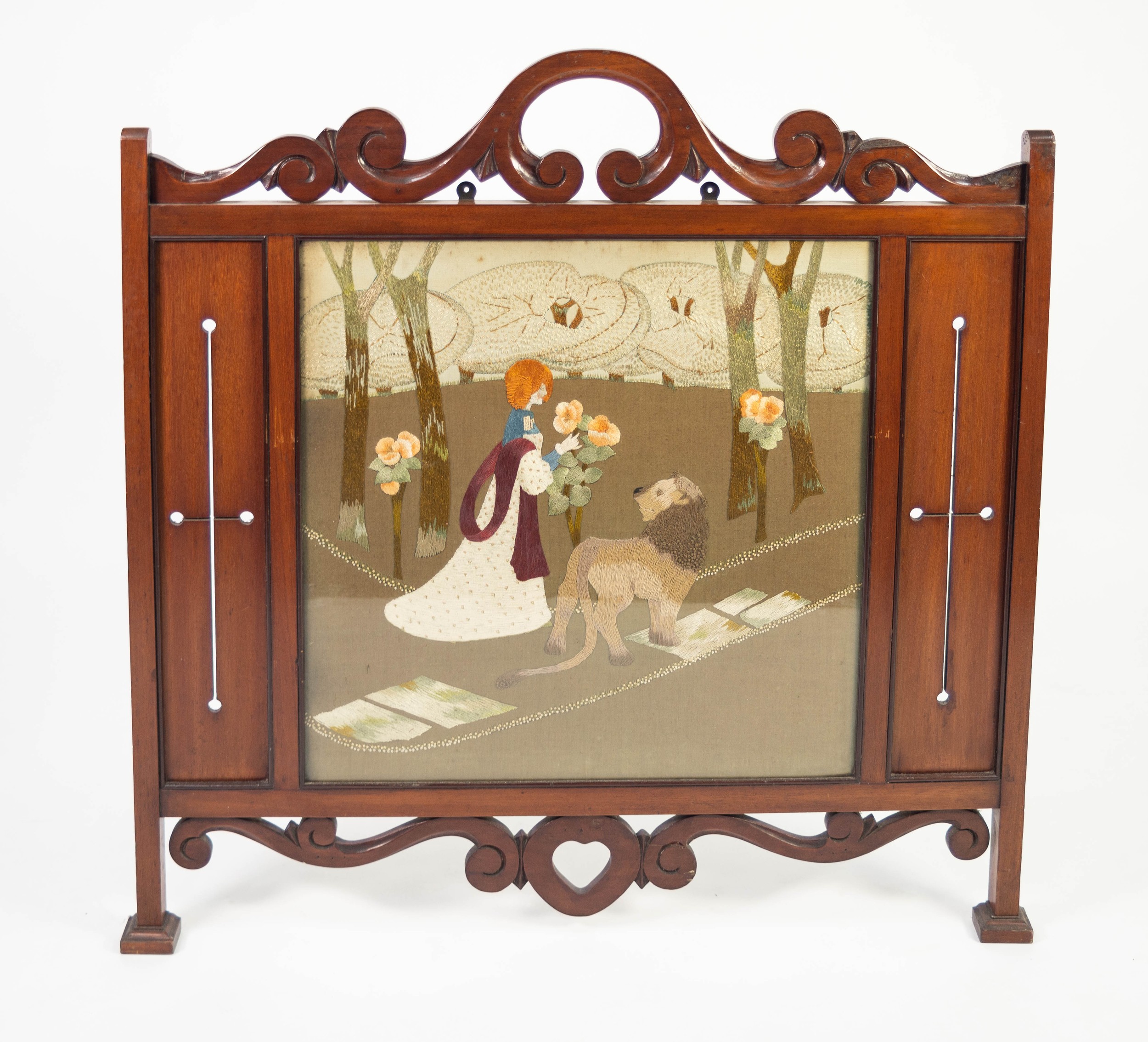 ARTS AND CRAFTS MAHOGANY AND NEEDLEWORK FIRE SCREEN, the pierced, scroll cresting above a glazed