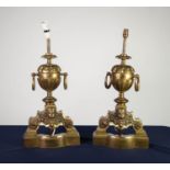 PAIR OF BRONZE CHENET PATTERN TABLE LAMPS, each with central two handled urn, above a mask capped