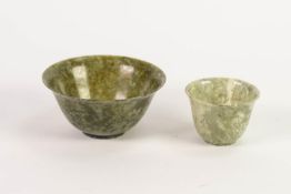 TWO CHINESE CARVED MOTTLED GREEN HARDSTONE BOWLS, both of steep sided, footed form, 2? (5.1cm) high,