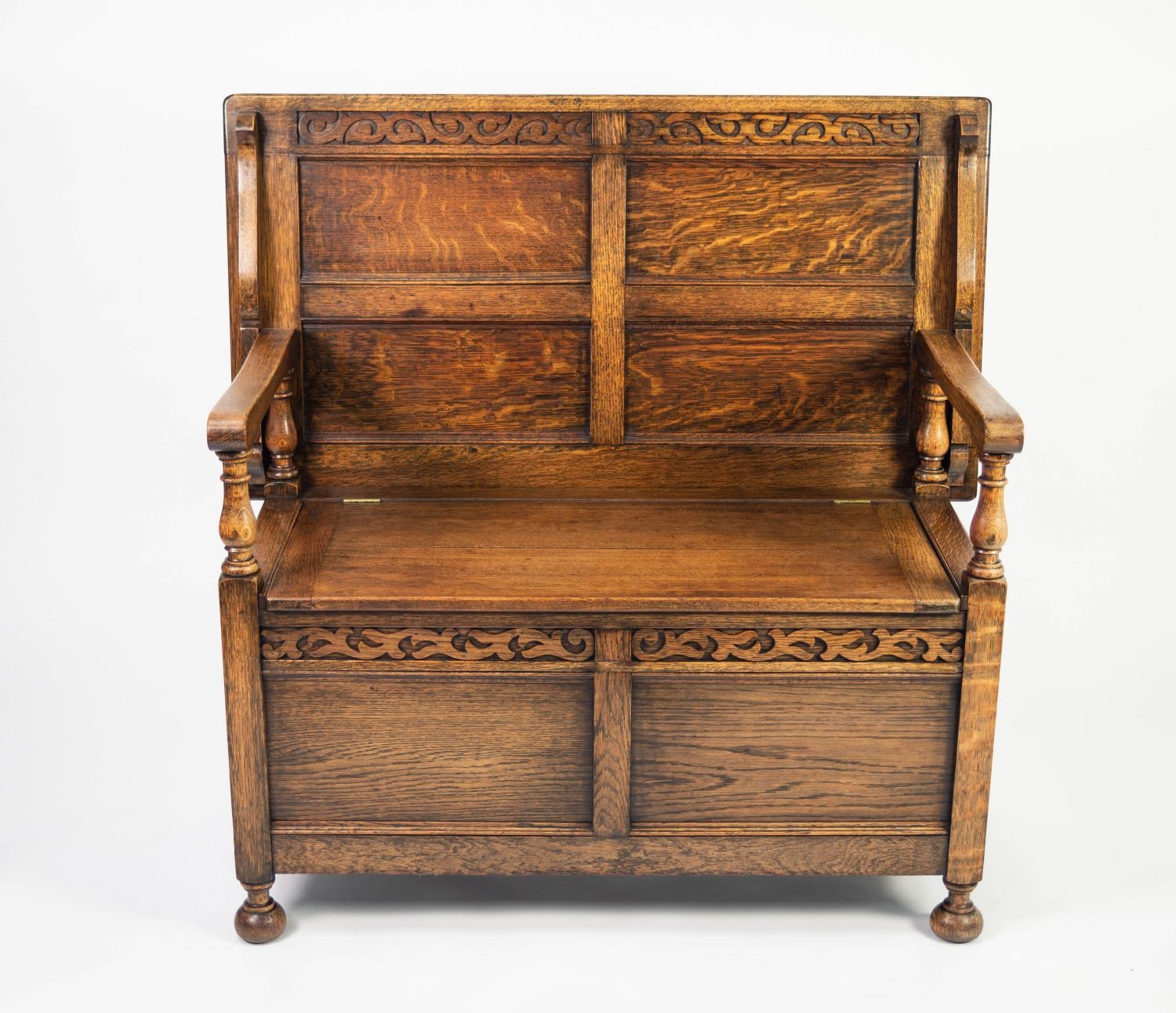 TWENTIETH CENTURY CARVED OAK MONK?S BENCH, of typical form with baluster supports to the flat