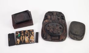 THREE CHINESE INK STONES, comprising: one in a hardwood box, another with leaf and berry carving