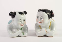 PAIR OF PORCELAIN MODELS OF SQUATTING INFANTS, as pillows, 9in (23cm) long