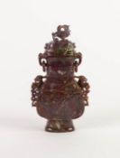 CHINESE CARVED MOTTLED PURPLE HARDSTONE TW HANDLED VASE AND COVER, of flattened form with captive