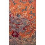 CHINESE NEEDLEWORK ORANGE/RED SILK PANEL, worked in colours with a detailed design of a snarling