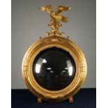 REGENCY STYLE CONVEX WALL MIRROR, circular with black reeded slip, the moulded frame with displaying