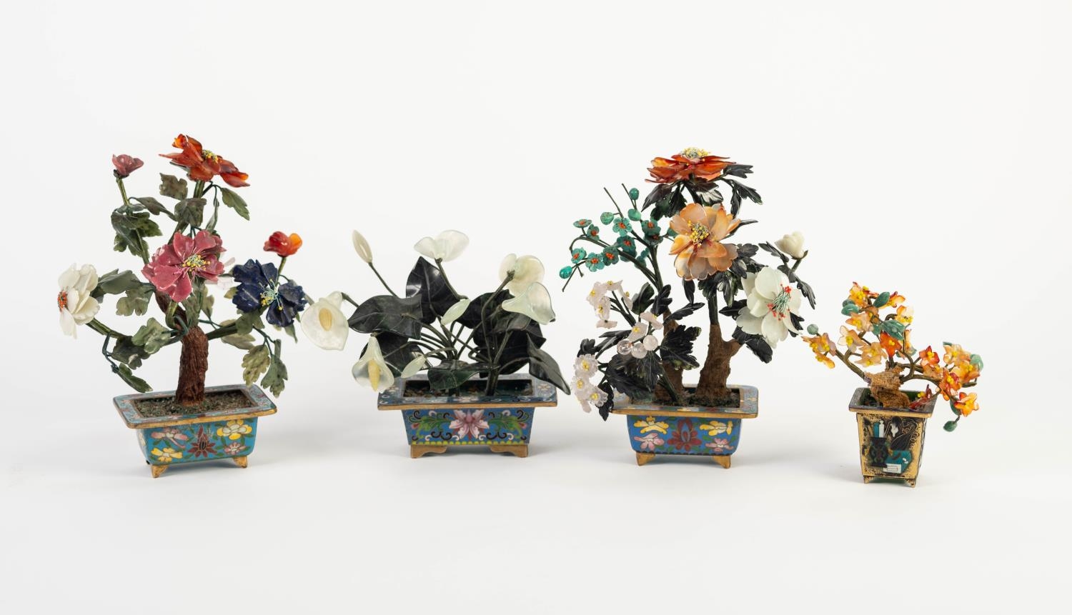 FOUR CHINESE CARVED HARDSTONE SMALL MODELS OF BONSAI TREES IN OBLONG CLOISONNÉ PLANTERS, 7 ½? (19cm)