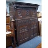 LATE 17th CENTURY CARVED OAK TWO-PART COURT CUPBOARD with later carved decoration of heads in