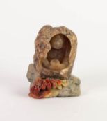 TWENTIETH CENTURY CARVED SOAPSTONE ORNAMENT DEPICTING A SEATED BUDDAH INSIDE A ROCK, with berries