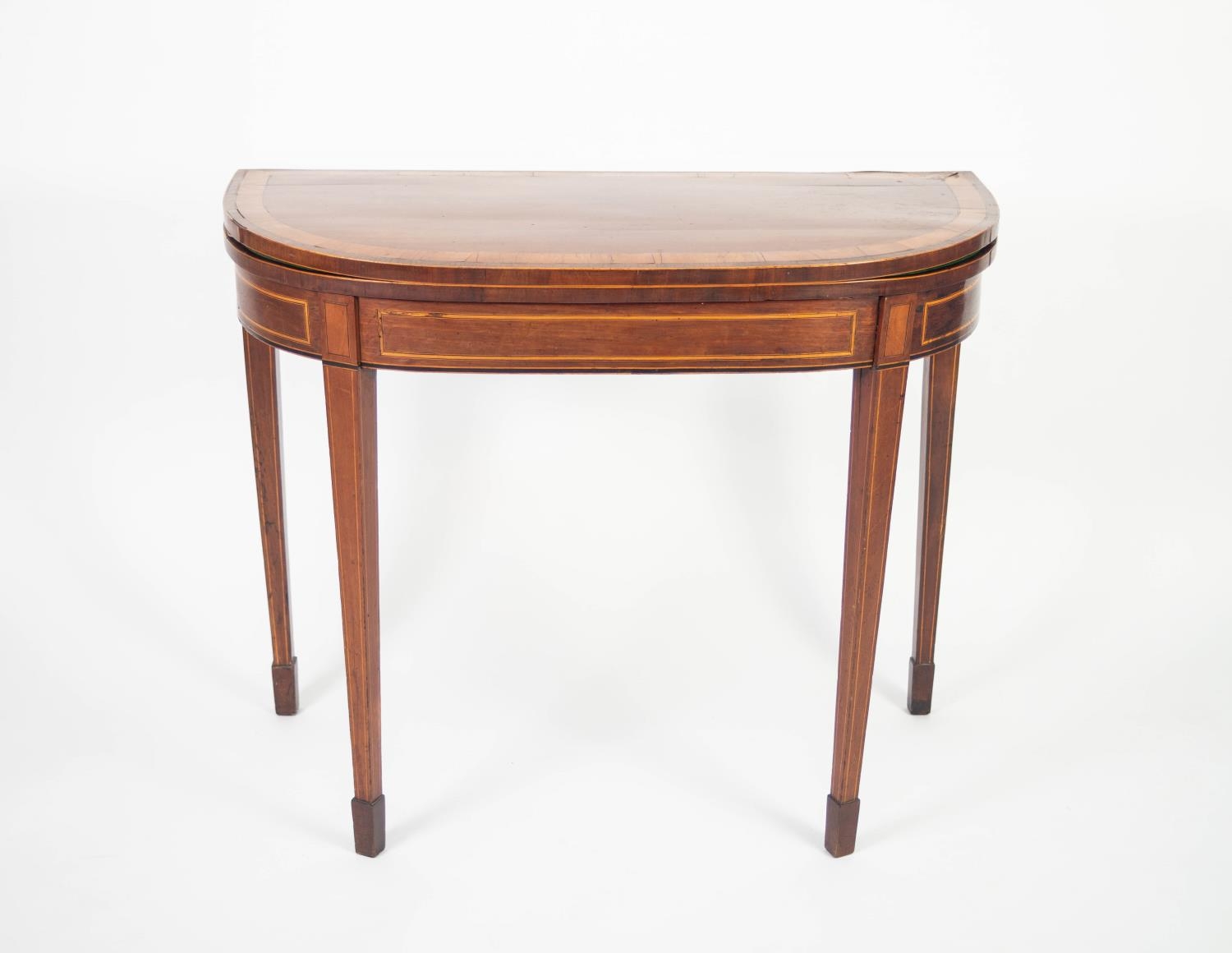 REGENCY MAHOGANY AND SATINWOOD CROSSBANDED CARD TABLE, the fold-over D shaped top enclosing a