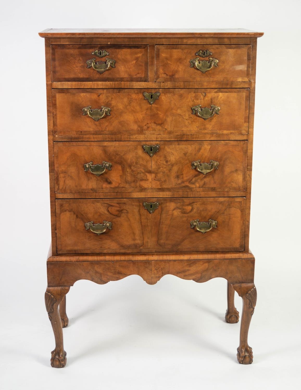 QUEEN ANNE STYLE REPRODUCTION FIGURED AND CROSSBANDED WALNUT CHEST ON STAND, the moulded top above