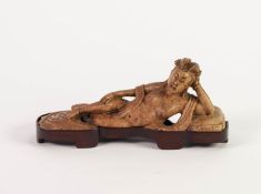 ORIENTAL CARVED SOAPSTONE NAKED FEMALE FIGURE, modelled reclining with her head raised and resting