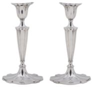 A pair of George V silver candlesticks