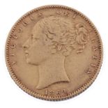 A Victorian shield back sovereign dated 1864