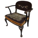 An early 20th century japanned black lacquer and gilt chinoiserie open armchair