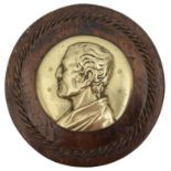A 19th century circular brass relief profile plaque of the Duke of Wellington