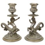 A pair of Italian silver cast candlesticks in the form of centurion sea gods (ichthyocentaurs)