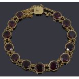 An early 20th century garnet and yellow gold flexible line bracelet