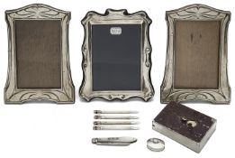 A pair of Edwardian Art Nouveau silver photograph frames, set of bridge pencils; other silver items