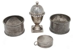 A late Victorian silver tape measure, a Victorian pepper pot and a pair of napkin rings