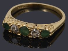 An early 20th c. emerald and diamond five stone ring