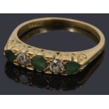 An early 20th c. emerald and diamond five stone ring