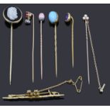 Six assorted stick pins and a bar brooch