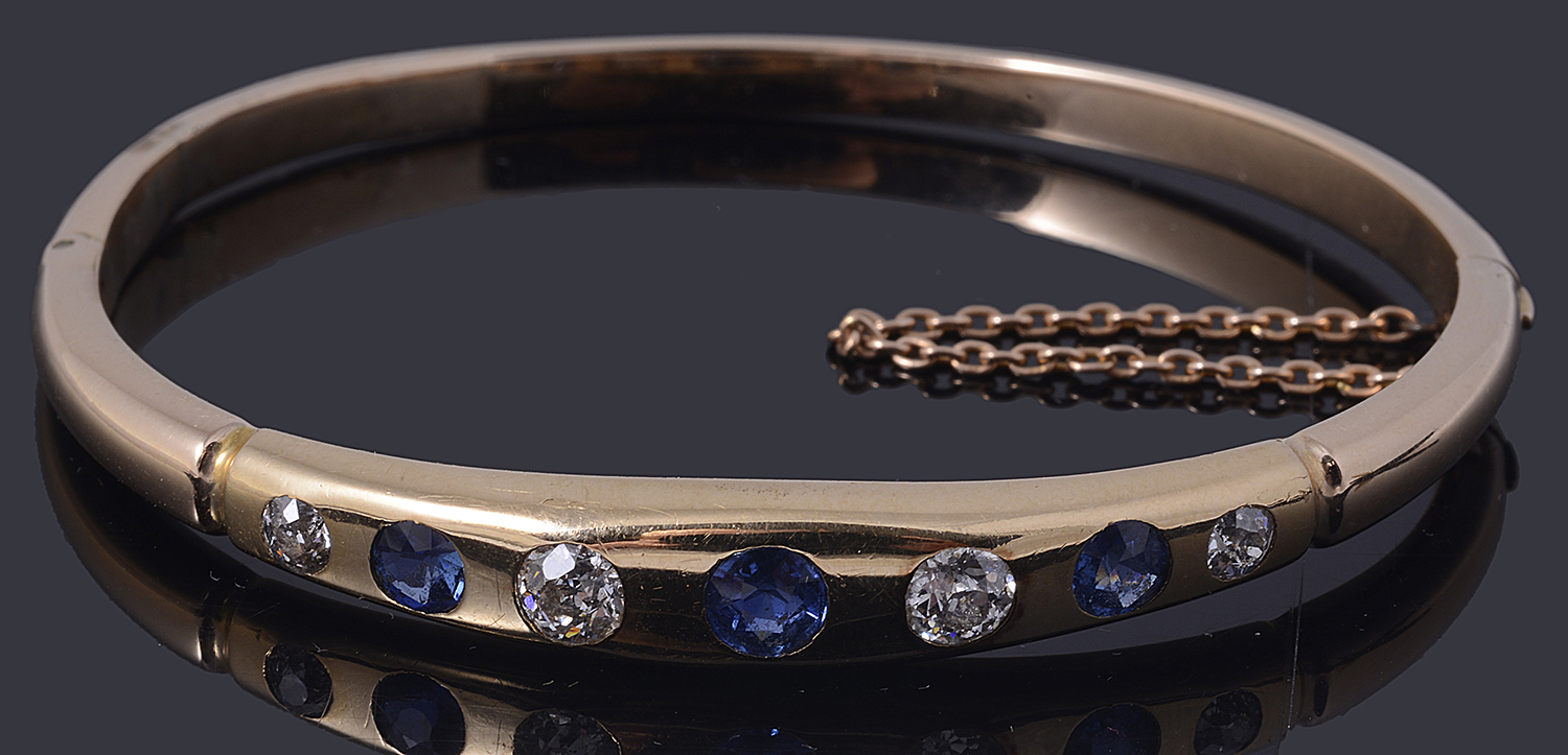 A gold sapphire and diamond hinge bangle