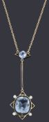 An Art Deco aquamarine and seed pearl pendant on chain