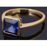 A delicate single stone square shaped step cut synthetic sapphire ring,