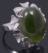 A white metal single stone green stone ring