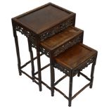 A late 19th century Chinese hardwood nest of three occasional tables