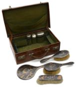 A George V silver mounted pique inlaid tortoiseshell four piece dressing table set; other