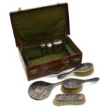 A George V silver mounted pique inlaid tortoiseshell four piece dressing table set; other