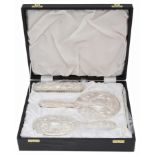A contemporary silver backed four piece dressing table set in a fitted case
