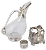 A German Jugendstil design pewter bottle holder, a duck shaped electroplated and glass claret jug