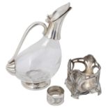 A German Jugendstil design pewter bottle holder, a duck shaped electroplated and glass claret jug