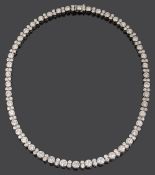 An impressive diamond necklace, flexible graduated row of 46 brilliant-cut diamonds, Harrods, London