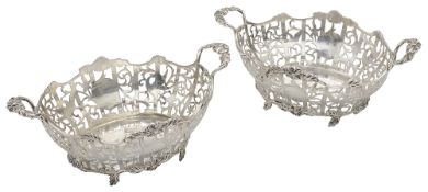 A pair of George V silver twin handled baskets in George III style