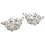 A pair of George V silver twin handled baskets in George III style