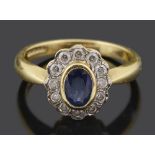 A contemporary oval sapphire and diamond cluster ring