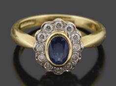 A contemporary oval sapphire and diamond cluster ring