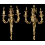 A pair of 19th century French Louis XVI style ormolu three light wall appliques