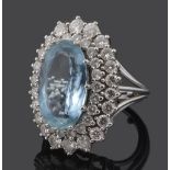 A large oval aquamarine and diamond cluster ring