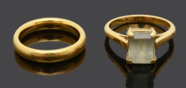 A single stone gem set ring and 22ct gold wedding band